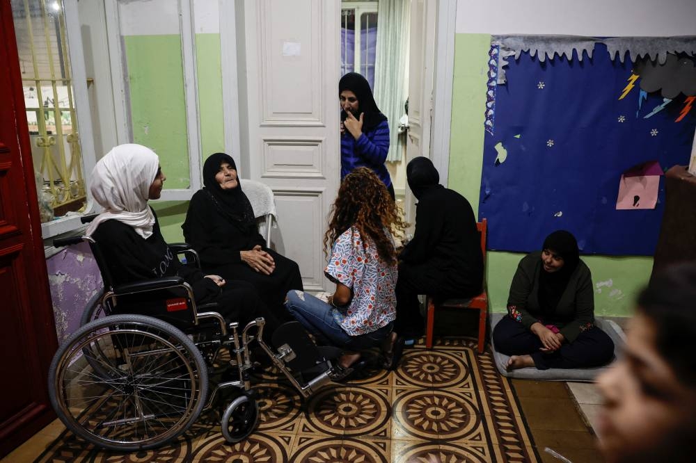 Displaced  families chat in a school which provides them temporary shelter, in Beirut, Lebanon, on Monday. REUTERS