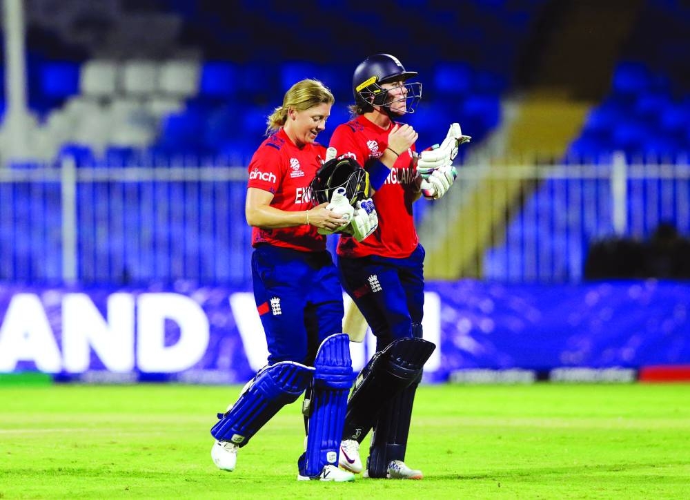 England’s Nat Sciver-Brunt and Heather Knight celebrate after winning the Women’s Cricket T20 World Cup match against South Africa at Sharjah Cricket Stadium on Monday. (Reuters)