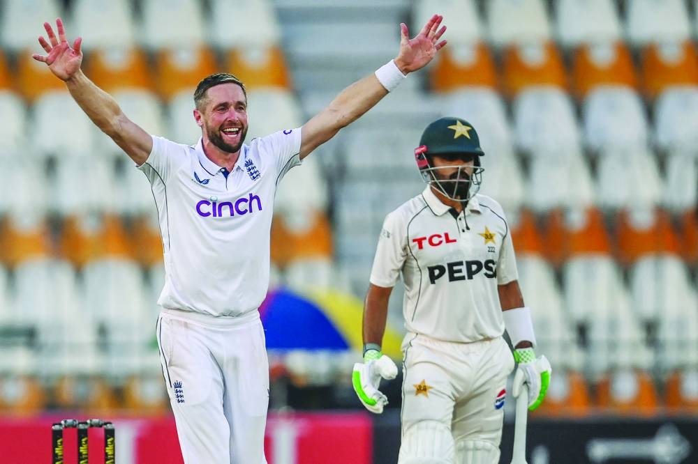 England’s Chris Woakes successfully appeals for leg before wicket against Pakistan’s Babar Azam during the first day of the first Test at the Multan Cricket Stadium on Monday. (AFP)