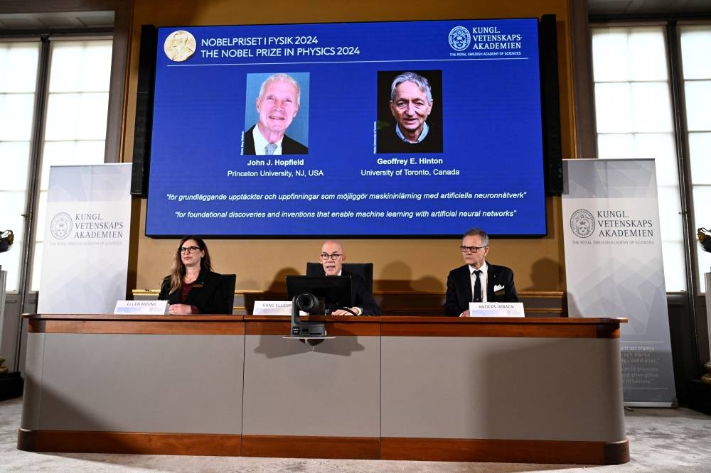 John J Hopfield and Geoffrey E Hinton are awarded this year's Nobel Prize in Physics, which is announced at a press conference by Hans Ellegren (centre), Secretary General at the Swedish Academy of Sciences, Stockholm, Sweden, on Tuesday. TT News Agency/Christine Olsson via REUTERS