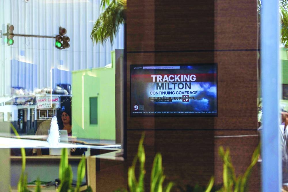 
A television screen at a business shows the local news channel as the community prepares for Hurricane Milton in Orlando, Florida. – AFP 