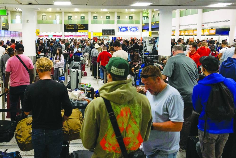 Travellers queue at London Gatwick Airport. The market for air travel remains hot as is evident from the load factor, which reached record high of 86.2% in August.