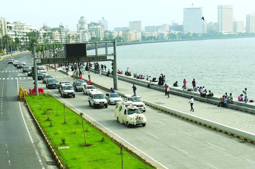 
A hearse van carrying the body of former chairman of Tata Group Ratan Tata, moves along the Marine Drive for his funeral in Mumbai, India, yesterday. 