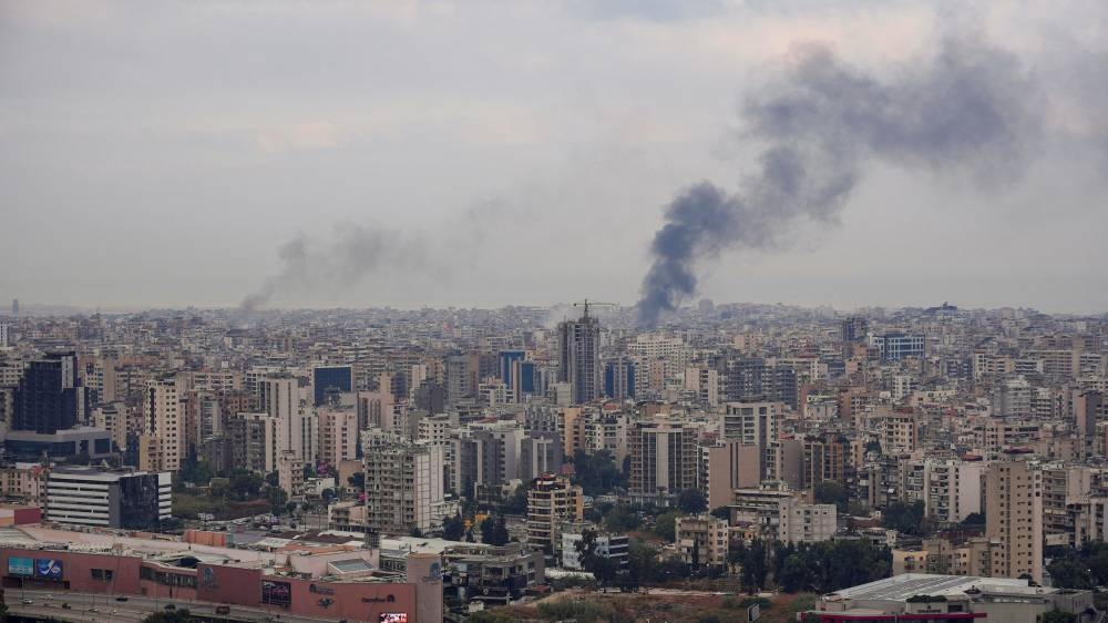 Smoke billows over Beirut's southern suburbs, as seen from Sin El Fil, Lebanon, on Friday. REUTERS
