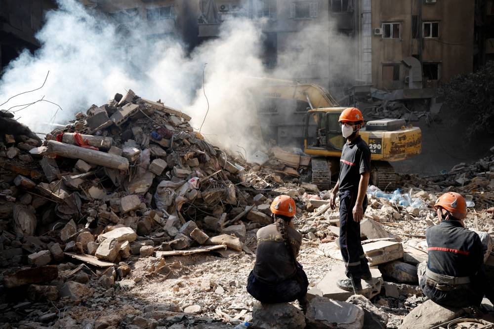 Emergency personnel work at the site of an Israeli air strike, in Beirut, on Friday. REUTERS