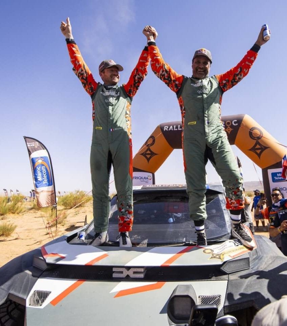  Nasser al-Attiyah celebrates with his co-driver Edouard Boulanger after winning his seventh Rally of Morocco title Friday. 