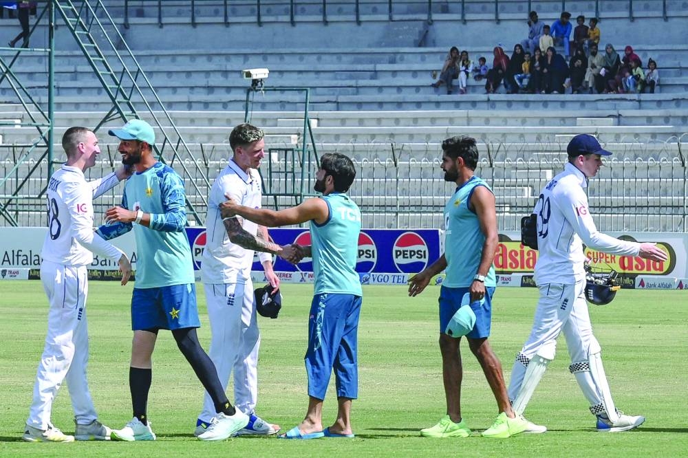 Players shake hands at the end of the first Test between Pakistan and England at the Multan Cricket Stadium on Friday. (AFP)