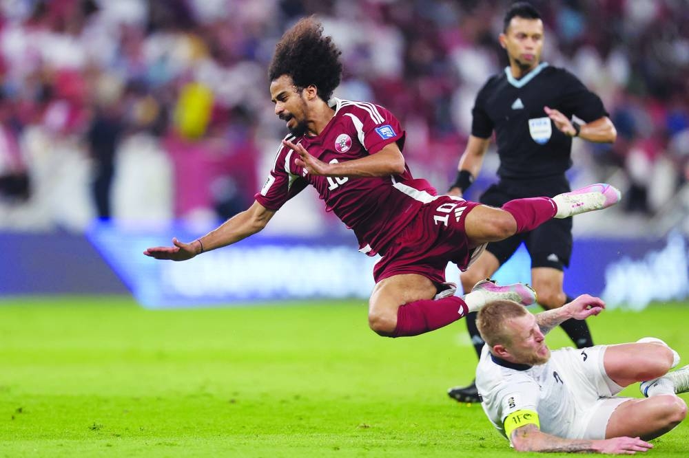 
Qatar’s Akram Afif goes down after being tackled by Kyrgyzstan’s Valerii Kichin during the 2026 World Cup Asian qualification match at the Al Thumama Stadium in Doha. 