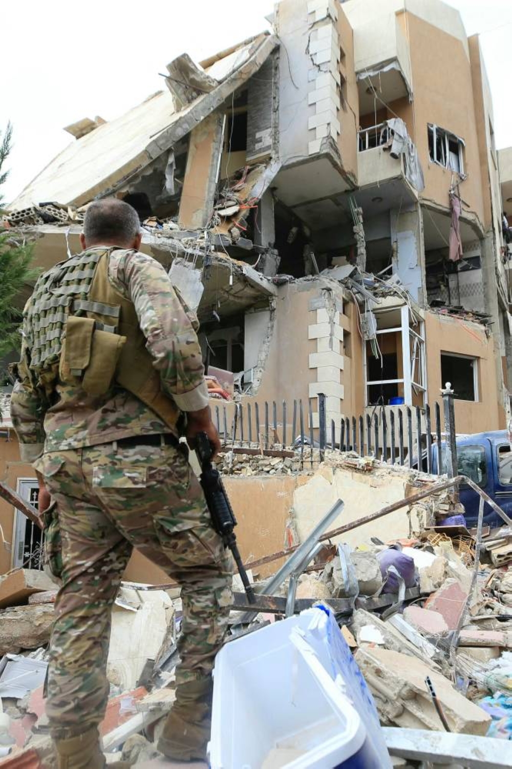 A Lebanese army soldier stands guard at the damage at the site of an Israeli airstrike that targeted an apartment building in town of Bajra south of Beirut on Saturday. AFP