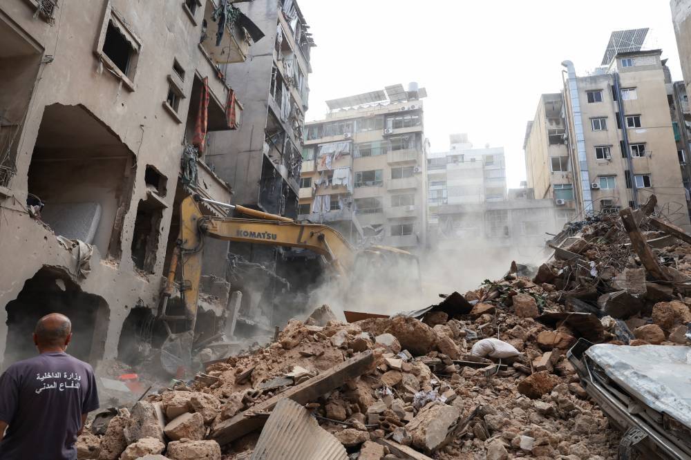 A machinery clears rubble at a site of an Israeli strike, amid ongoing hostilities between Hezbollah and Israeli forces, in Beirut ,on Saturday. REUTERS