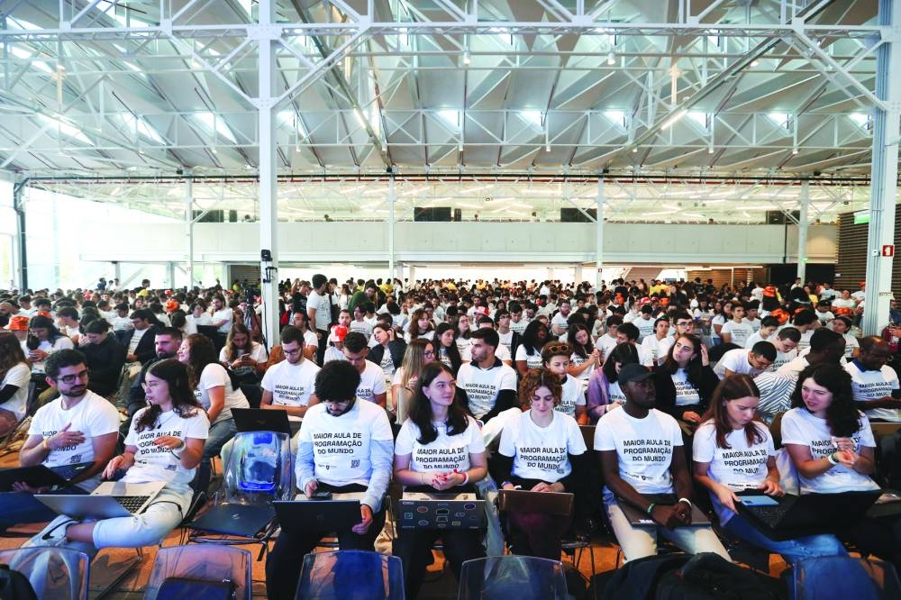 
Students participate in an event to attempt to break the Guinness Record for the world’s largest computer programming lesson at a university in Lisbon. – Reuters 