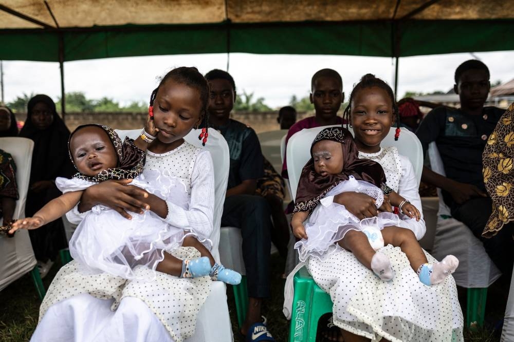 Twins look on as they attend the Igboora World Twins Festival 2024, in Igbo-Ora on Saturday. AFP