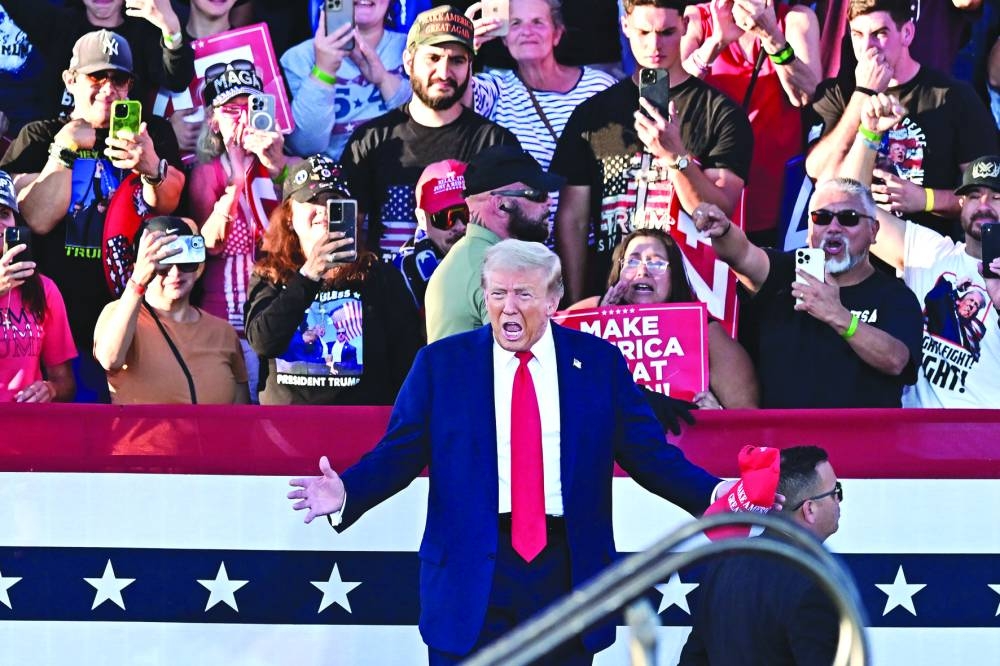 Former US president and Republican presidential candidate Donald Trump gestures as he arrives for a campaign rally at Calhoun Ranch in Coachella, California. (AFP)