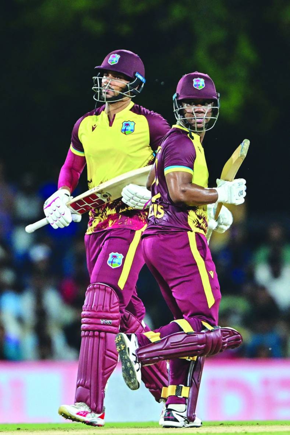 West Indies’ Evin Lewis (left) and Brandon King run between the wickets during the first Twenty20 international against Sri Lanka in Dambulla on Sunday. (AFP)