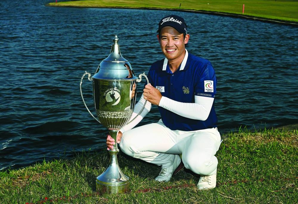 
Rattanon Wannasrichan of Thailand posing with the trophy after winning in the Macau Open at the Macau Golf and Country Club. (AFP) 