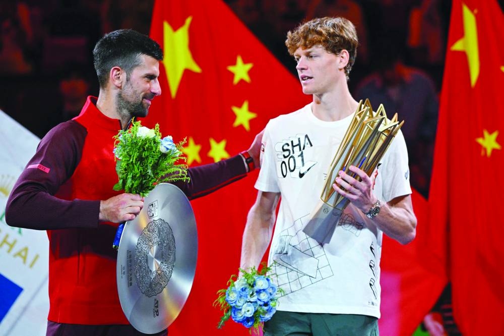 Italy’s Jannik Sinner (right) is greeted by Serbia’s Novak Djokovic after Sinner won their singles final match at the Shanghai Masters on Sunday. (AFP)