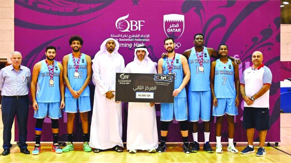 Mohammed bin Saad al-Mughaiseeb, President of the Qatar Basketball Federation (QBF), Yassin Ismail, General Supervisor of the 3x3 competitions, and Essam Lotfi, Technical Expert at QBF, with the Qatar 3x3 Basketball League Runners-up Al Wakrah.. 