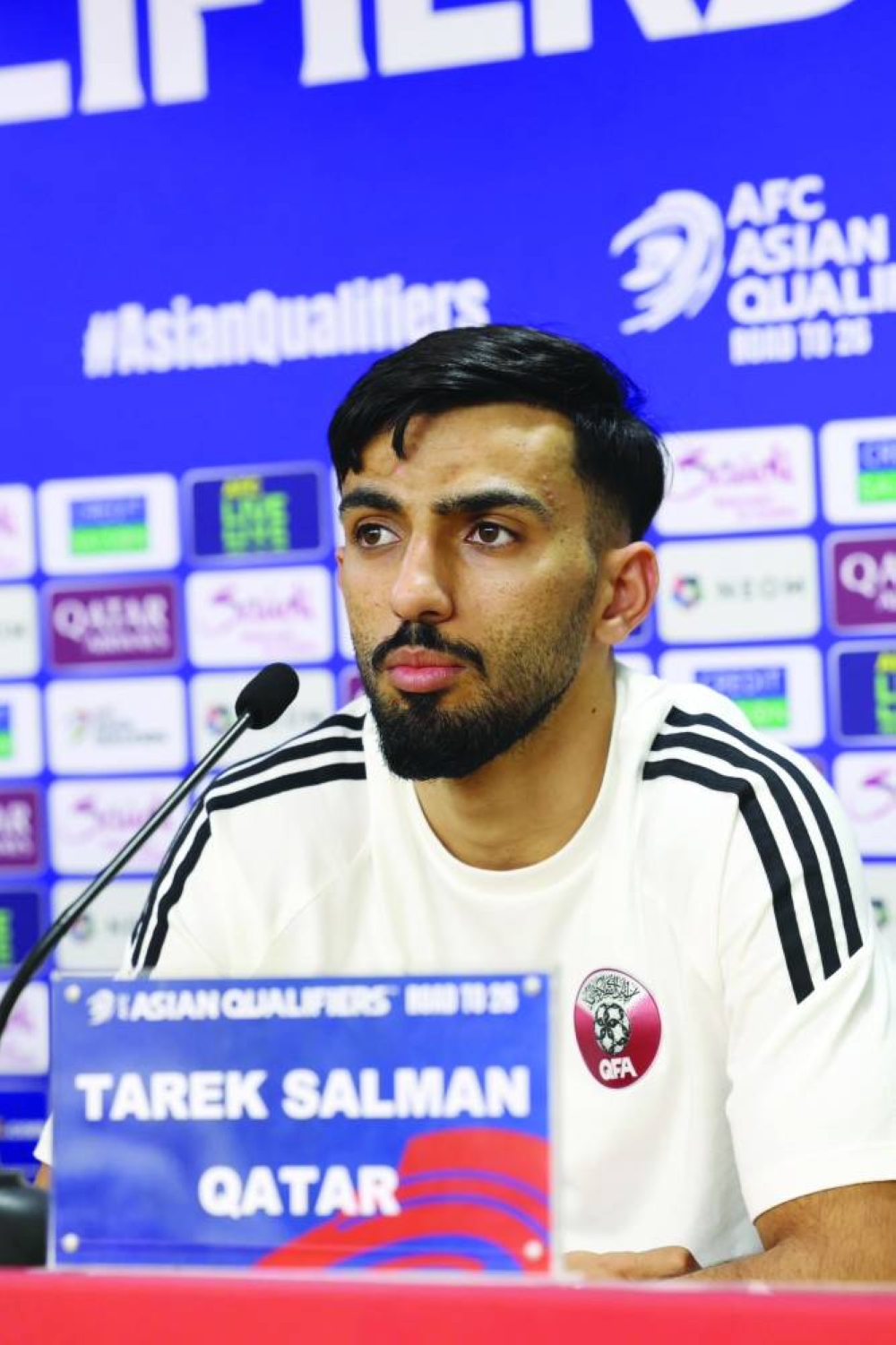 Qatar defender Tariq Salman takes questions during a news conference in Dubai yesterday. 