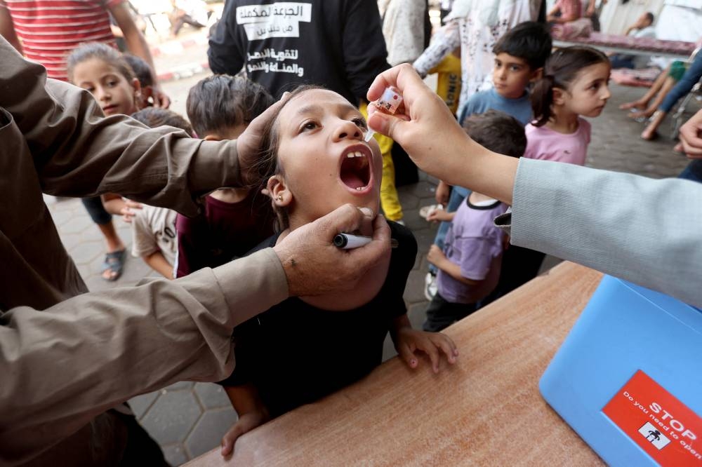 Palestinian child is vaccinated against polio during the second round of a vaccination campaign in Deir Al-Balah in the central Gaza Strip, on Monday. REUTERS