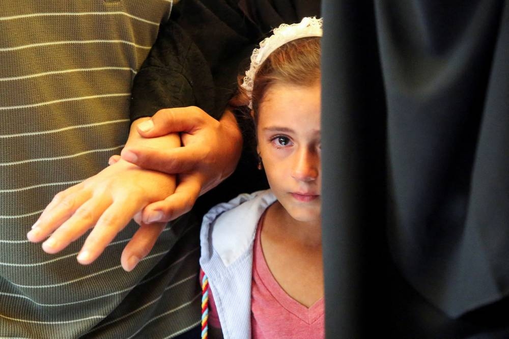 A relative of Palestinians from Abu Taima family, who were killed in an Israeli strike attends their funeral at Nasser hospital in Khan Younis, in the southern Gaza Strip, on Tuesday. REUTERS