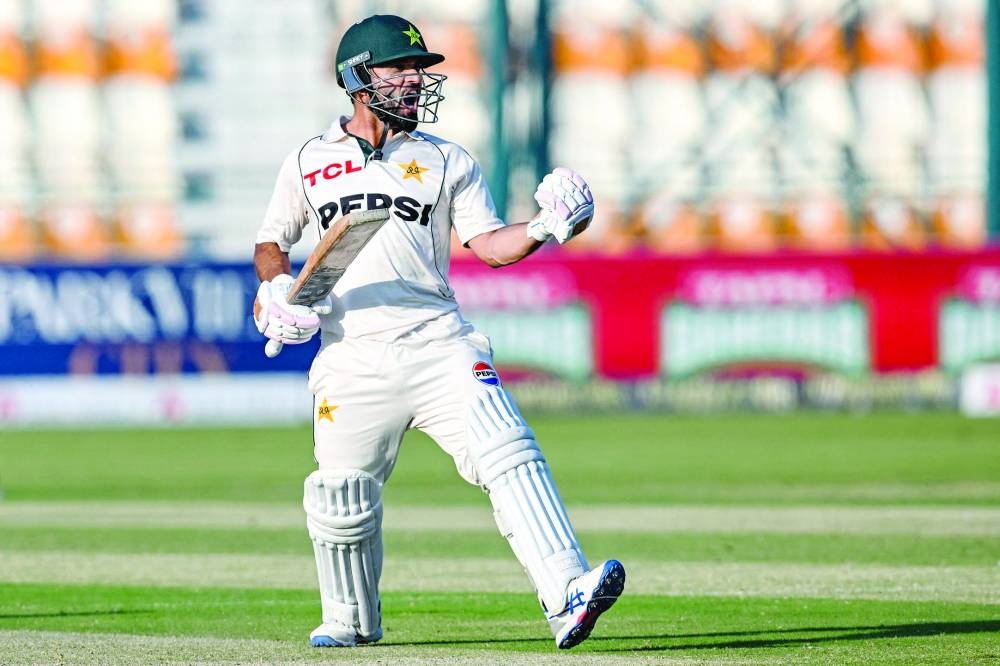 Pakistan’s Kamran Ghulam celebrates after scoring a century during the first day of the second Test against England at the Multan Cricket Stadium in Multan on Tuesday. (AFP)