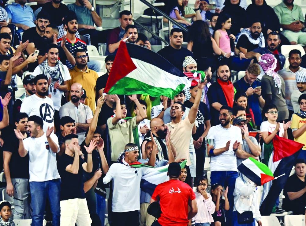 Fans of Palestine cheer during the FIFA 2026 World Cup Asian Qualifiers third round Group B match against Kuwait at Jassim Bin Hamad Stadium in Doha on Tuesday. Picture: Noushad Thekkayil