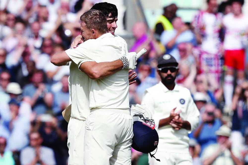 England’s Alastair Cook (left) is embraced by England’s Joe Root as he celebrates his century during play on the fourth day of the fifth Test against India at The Oval in London on September 10, 2018. (AFP/File Picture)