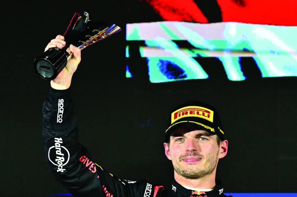 
Second placed Red Bull Racing’s Dutch driver Max Verstappen celebrates on the podium after the Formula One Singapore Grand Prix night race at the Marina Bay Street Circuit in Singapore on September 22, 2024. (AFP) 