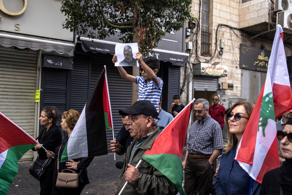 A young Palestinian boy holds up a portrait of slain Hamas leader Yahya Sinwar during a rally in Ramallah, in the Occupie-West Bank on  Friday. AFP