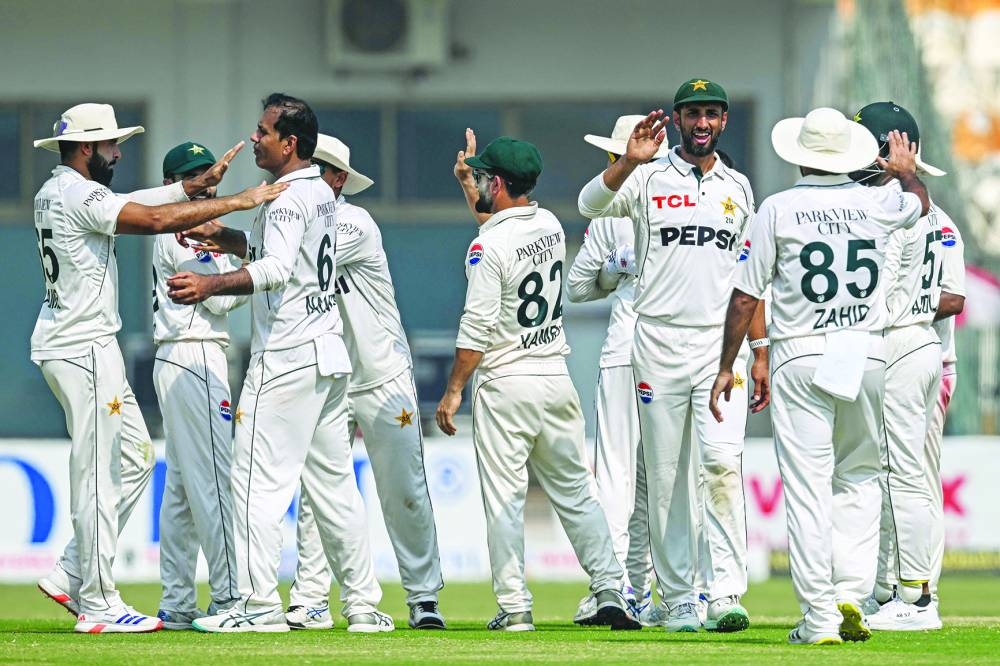 Pakistan’s players celebrate winning the second Test against England at the Multan Cricket Stadium in Multan on Friday. (AFP)