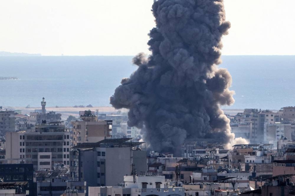 Thick smoke billows over buildings following an Israeli airstrike on Beirut's southern suburbs on Saturday. AFP