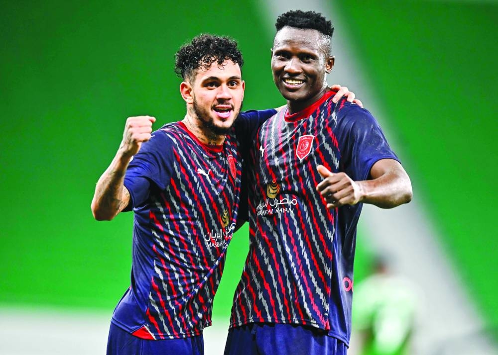 Al Duhail’s Michael Olunga (right) celebrates with Edmilson Junior after scoring against Al Ahli at the Al Thumama Stadium on Saturday. PICTURE: Noushad Thekkayil