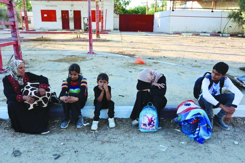 Displaced Palestinians, ordered by the Israeli army to leave the school in Beit Lahia where they were sheltered, rest as they arrive in Gaza City Saturday. Gaza's civil defence agency said more than 400 Palestinians were killed in the north of the territory over the past two weeks during an ongoing Israeli military assault which has displaced tens of thousands.