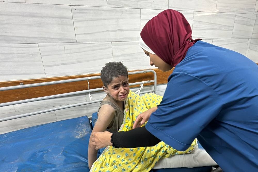 A Palestinian child receives treatment at the Kamal Adwan Hospital after an Israeli airstrike in Beit Lahia, in the northern Gaza Strip on on Saturday. AFP