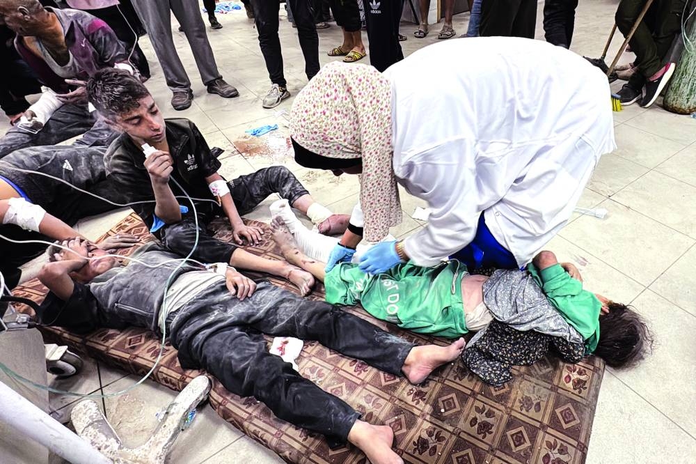 Wounded Palestinians receive treatment at the Kamal Adwan Hospital after an Israeli airstrike in Beit Lahia, on Sunday.