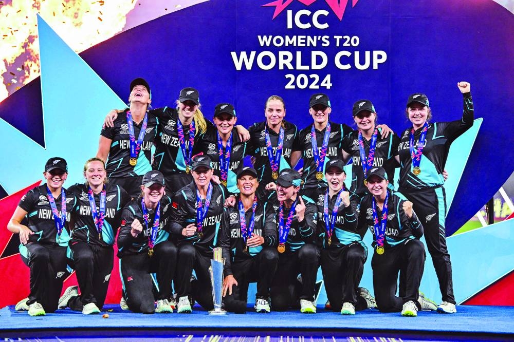 
New Zealand’s players celebrate with the trophy at the end of the ICC Women’s T20 World Cup final match against South Africa at the Dubai International Cricket Stadium yesterday. (AFP) 