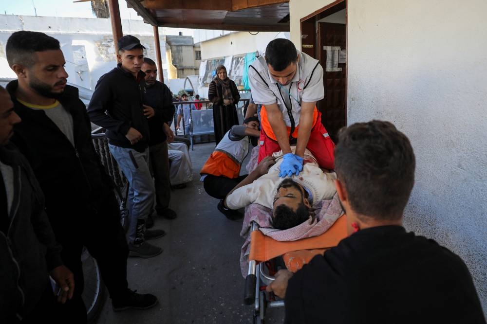 A paramedic tries to resuscitate Palestinian Ahmed Shnewra, who was mortally wounded in an Israeli strike, in Gaza City, on Tuesday. REUTERS