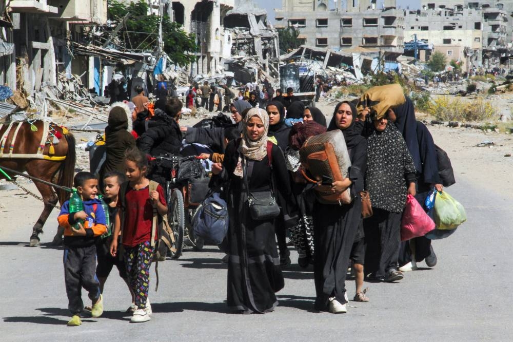 Displaced Palestinians ordered by the Israeli military to evacuate the northern part of Gaza flee amid an Israeli military operation, in Jabalia in the northern Gaza Strip on Tuesday. REUTERS