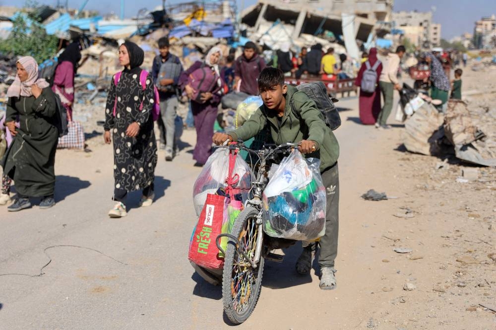 Displaced Palestinians fleeing Israeli military operations making their way to Gaza City Tuesday.