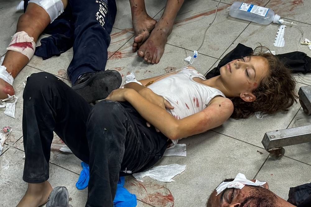 Palestinians injured in Israeli bombardment of the Beit Lahia Project area are laid on the floor awaiting treatment at the Kamal Adwan Hospital in Beit Lahia in the northern Gaza Strip on Wednesday. AFP