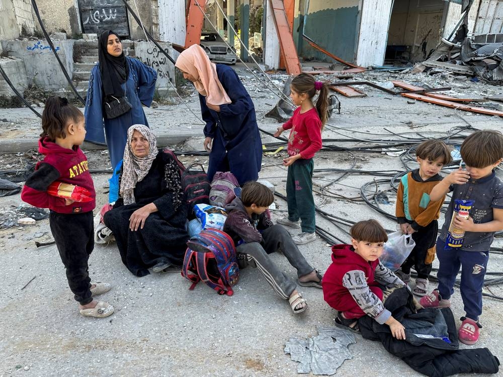 Displaced Palestinians ordered by the Israeli military to evacuate the northern part of Gaza take a rest as they flee amid an Israeli military operation, in Jabalia in the northern Gaza Strip on Wednesday. REUTERS
