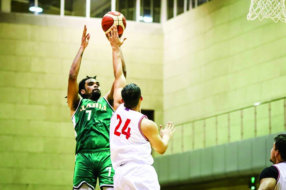 Al Ahli's Raekwon Deshawn Rogers (in Green) and and Al Shamal's Mohamed Hassan in action during the Qatar Cup basketball tournament yesterday.