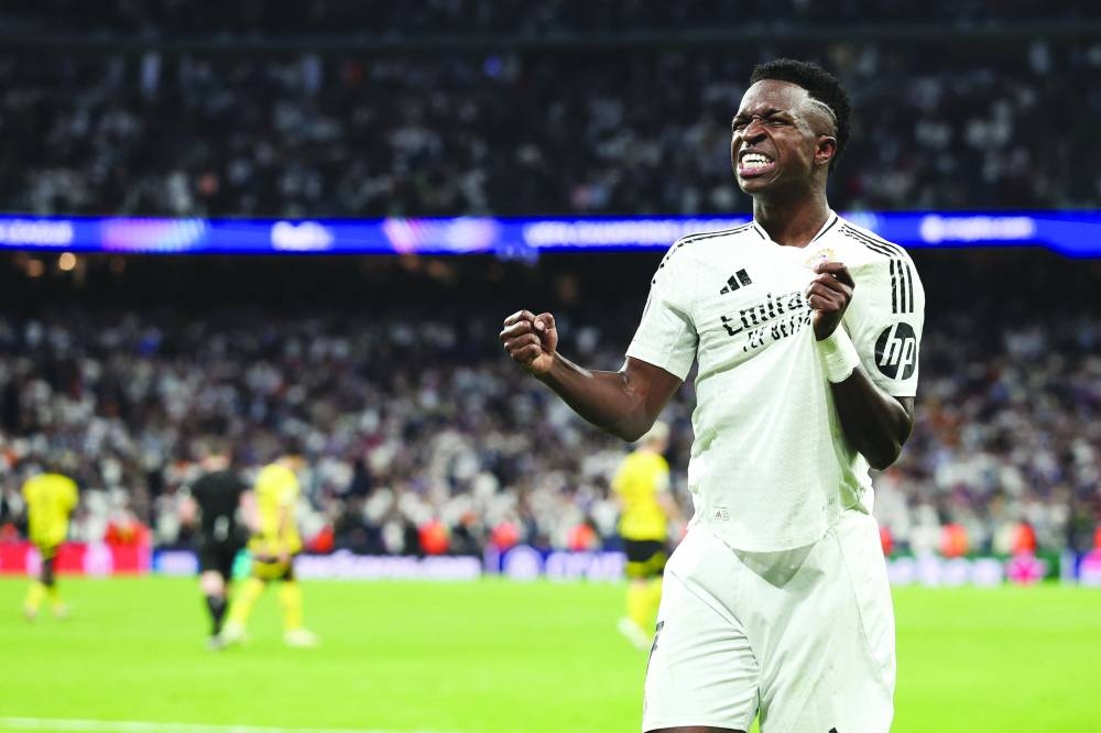 Real Madrid's Brazilian forward #07 Vinicius Junior celebrates after scoring their fifth goal during the UEFA Champions League, league phase day 3 football match between Real Madrid CF and Borussia Dortmund at the Santiago Bernabeu stadium in Madrid on October 22, 2024. (Photo by Thomas COEX / AFP)