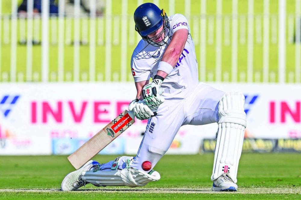 
England’s Jamie Smith plays a shot during the first day of the third and final Test against Pakistan at the Rawalpindi Cricket Stadium yesterday. Right: Pakistan’s Sajid Khan celebrates after taking the wicket of England’s Harry Brook. (AFP/Reuters) 