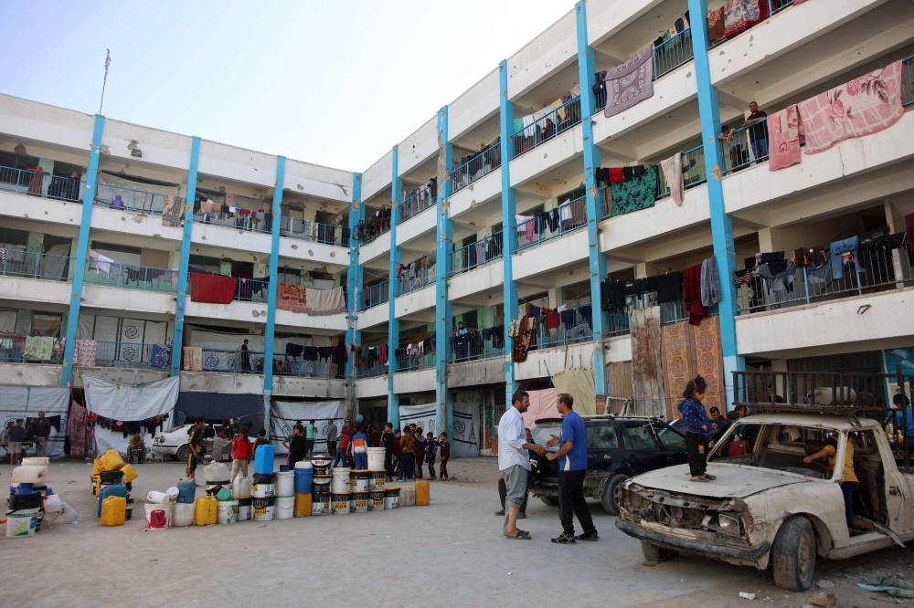 Displaced Palestinians gather in the courtyard of a UN school-turned shelter in the Nasser district of Gaza City, in the northern Gaza Strip on Friday. AFP