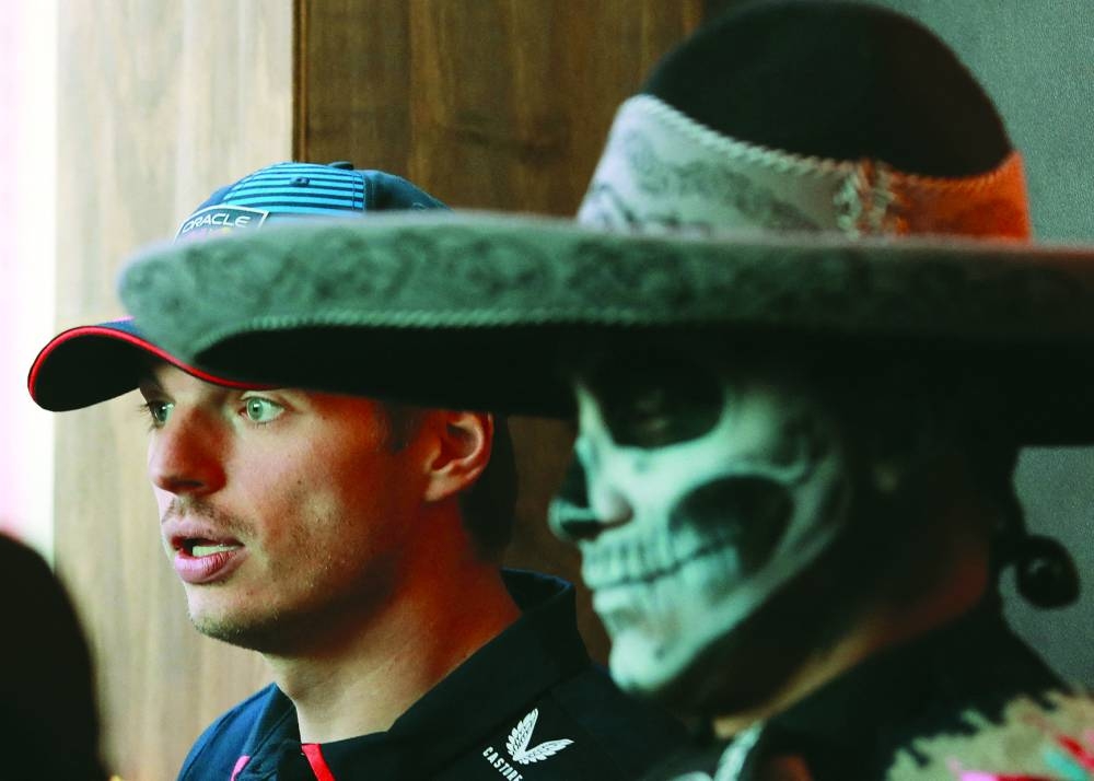 Red Bull’s Max Verstappen with a person dressed as a catrina ahead of the Mexico City Grand Prix at Autodromo Hermanos Rodriguez, Mexico City on Friday. (Reuters)