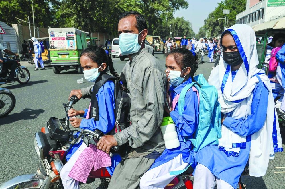 Schoolgirls leave school amid a rise in the levels of smog in Lahore. Schoolchildren in Pakistan’s second-largest city of Lahore have been banned from outdoor exercise until January because of hazardous smog levels, officials said on Friday. – AFP