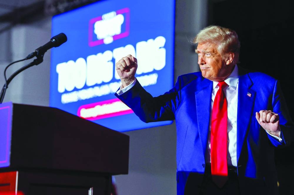 Trump dances on stage during a campaign rally at Suburban Collection Showplace in Novi, Michigan. – AFP