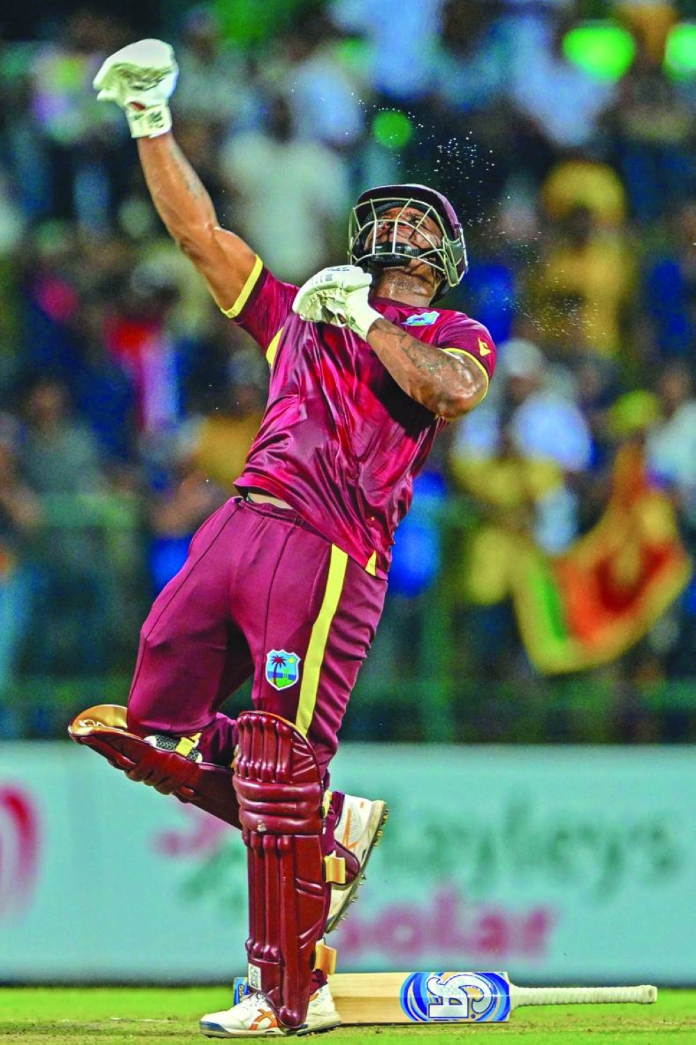 West Indies’ Evin Lewis celebrates after scoring century in the third ODI against Sri Lanka at the Pallekele International Cricket Stadium in Kandy on Saturday. (AFP)