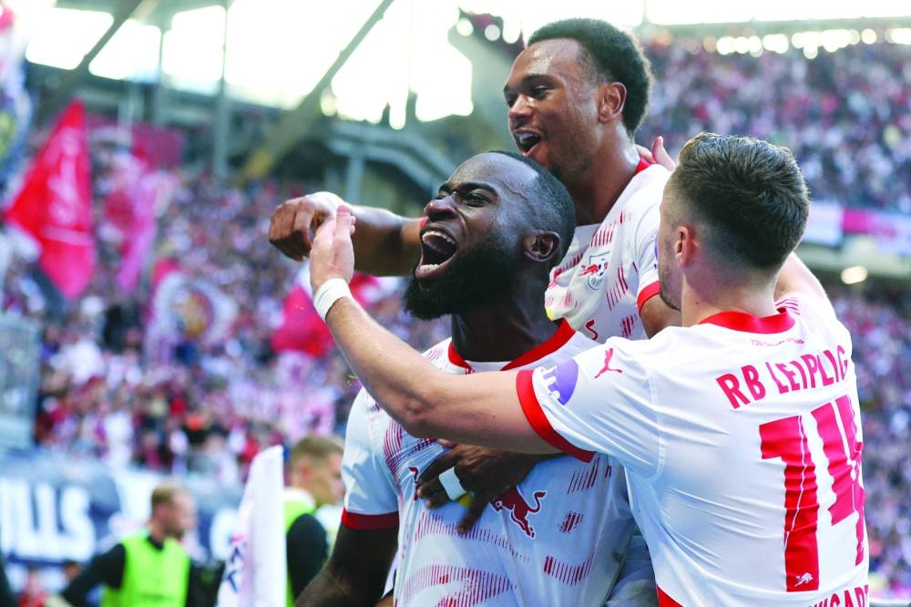 
Leipzig’s Lutsharel Geertruida (left) celebrates with teammates after scoring against Freiburg in the Bundesliga. (AFP) 